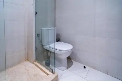 a bathroom with a toilet and a glass shower at Marrakech Calm Getaway 2 Pools & City Access in Marrakech