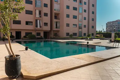 a swimming pool in front of a building at Marrakech Calm Getaway 2 Pools & City Access in Marrakech