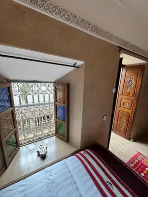 a bedroom with a bed and a window at Échappée onirique au cœur de la Cité Ocre in Marrakech