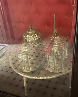two silver urns on a glass table in a room at Échappée onirique au cœur de la Cité Ocre in Marrakech