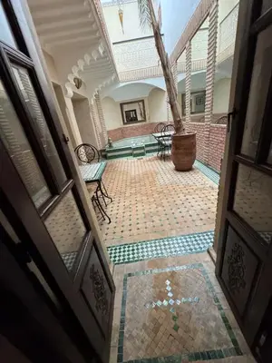 an open door of a building with a tile floor at Échappée onirique au cœur de la Cité Ocre in Marrakech