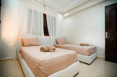 a bedroom with two beds and a window at New apartment rental in Marrakech