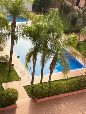 an overhead view of a swimming pool with palm trees at Mimi MARRAKECH in Marrakech