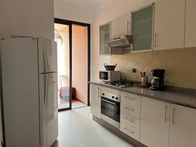 a kitchen with a refrigerator and a stove top oven at Mimi MARRAKECH in Marrakech
