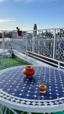 a table with a bowl and a vase on it at hostel Daryusssef114 in Marrakech