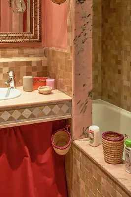 a bathroom with a sink and a counter with baskets at Condo in the Heart of the Palmeraie, Pools in Marrakech