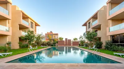 a swimming pool in the courtyard of a building at Luxueux appartement piscine coralia in Marrakech
