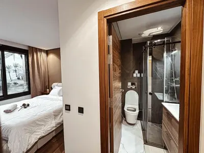 a bathroom with a bed and a toilet and a shower at Luxury Apt near Majorelle & City Center in Marrakech