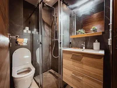 a bathroom with a toilet and a glass shower at Luxury Apt near Majorelle & City Center in Marrakech