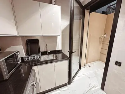 a small kitchen with a sink and a microwave at Luxury Apt near Majorelle & City Center in Marrakech