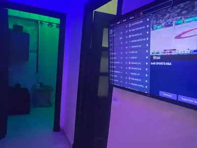 a projection screen in a room with purple lights at Sweet 1 Bed Room Appart in Marrakech