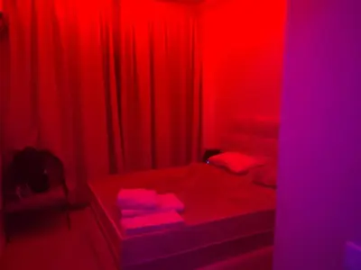 a red room with a bed and red curtains at Sweet 1 Bed Room Appart in Marrakech