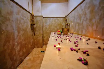 a bunch of flowers sitting on a table in a room at Riad Jô & Spa in Marrakech