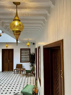 a large room with a chandelier hanging from a ceiling at Riad Jô & Spa in Marrakech