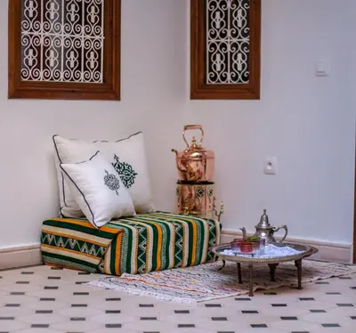 a living room with a couch and a table at Riad Jô & Spa in Marrakech