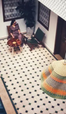a woman sitting in a chair in a room at Riad Jô & Spa in Marrakech
