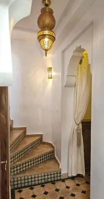 a chandelier and stairs in a room at Riad Jô & Spa in Marrakech