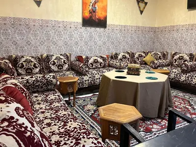 a living room with a couch and a table at Riad Flouris in marrakech in Marrakech