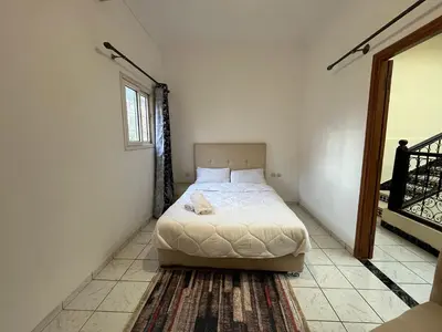 a bedroom with a bed in the corner of a room at Riad Flouris in marrakech in Marrakech