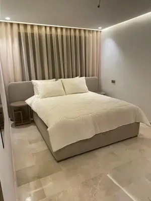 a bedroom with a large bed with white sheets at Éros in Marrakech