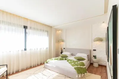 a bedroom with a large white bed and a window at splendid Villa King palace in Marrakech