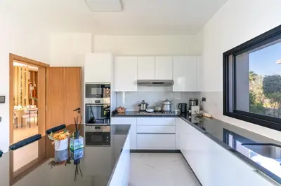 a kitchen with white cabinets and a window at splendid Villa King palace in Marrakech