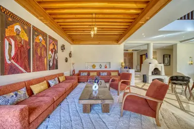 a living room with a couch and a table at Villa Juzyan Piscine-Jacuzzi-Pataugeoire-Pétanque in Marrakech