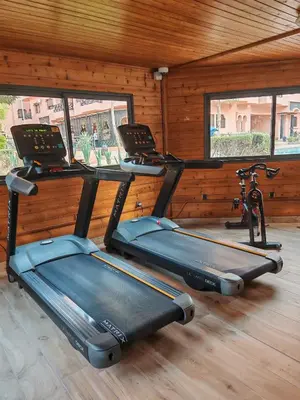 a gym with three exercise bikes in a room at Elegant Apartment with King-Size Bed, Premium Amenities, 5 Pools & Free Parking in Marrakech