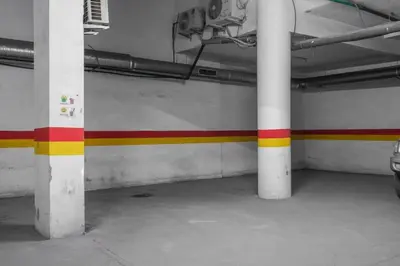 a room with red yellow and white columns in a building at 