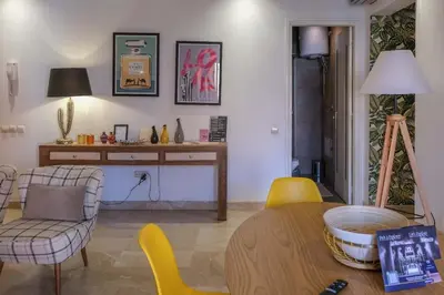 a living room with a table and yellow chairs at 