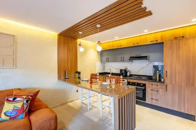 a kitchen with a table in the middle of a room at Modern Jewel Central and Premium comfort in Marrakech