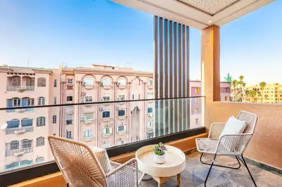 a balcony with chairs and a table and a window at Modern Jewel Central and Premium comfort in Marrakech