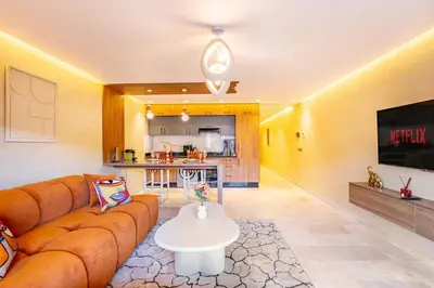 a living room with a couch and a kitchen at Modern Jewel Central and Premium comfort in Marrakech