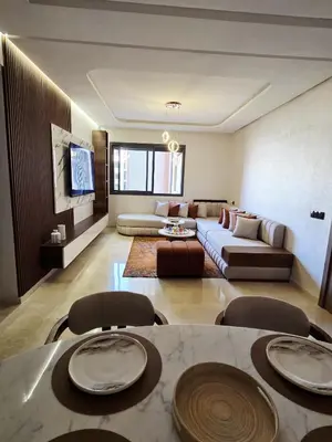 a living room with a couch and a table and chairs at Jnane el Ali Gueliz in Marrakech