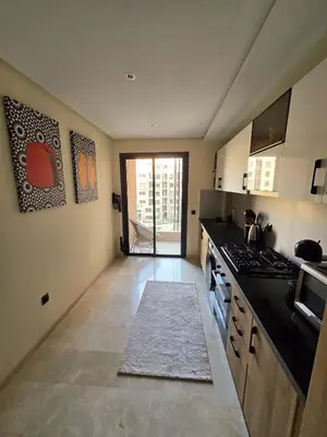 a kitchen with a stove and a counter top at Jnane el Ali Gueliz in Marrakech