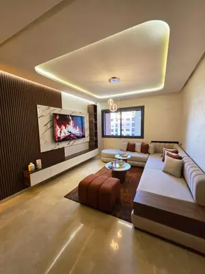 a living room with a couch and a tv at Jnane el Ali Gueliz in Marrakech