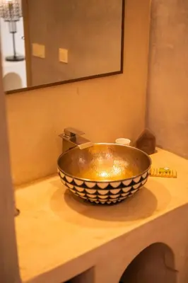 a bathroom sink with a large bowl on a counter at Riad Dar Amazonia in Marrakech