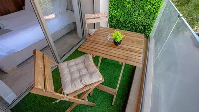 a small table and a chair on a balcony at Stylish Gueliz Getaway, Terrace & Parking in Marrakech