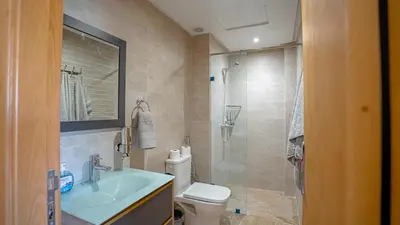 a bathroom with a toilet and a sink and a shower at Stylish Gueliz Getaway, Terrace & Parking in Marrakech