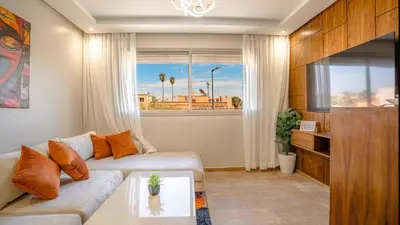 a living room with a couch and a window at Stylish Gueliz Getaway, Terrace & Parking in Marrakech