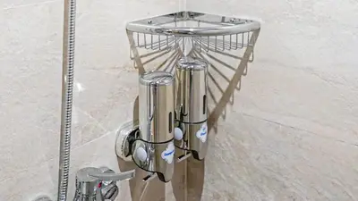 a metal rack with a shower head in a bathroom at Stylish Gueliz Getaway, Terrace & Parking in Marrakech