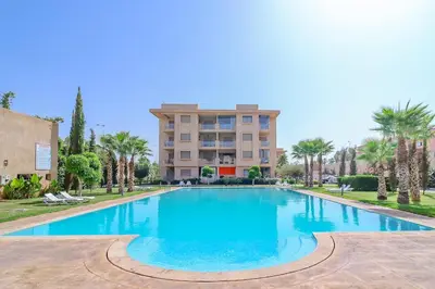 a large swimming pool in front of a building at New Charming apartment with swimming pool in Marrakech