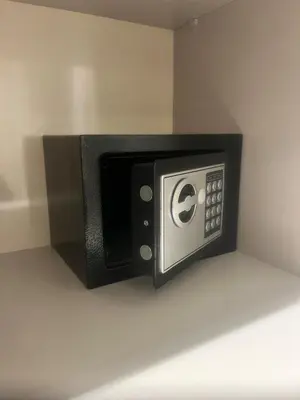 a black microwave oven on a wall at AquaEros - Appart Jacuzzi Carré Eden Marrakech in Marrakech