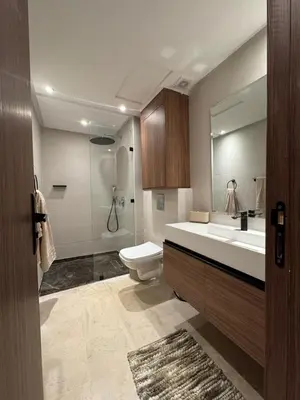 a bathroom with a toilet and a sink and a mirror at AquaEros - Appart Jacuzzi Carré Eden Marrakech in Marrakech