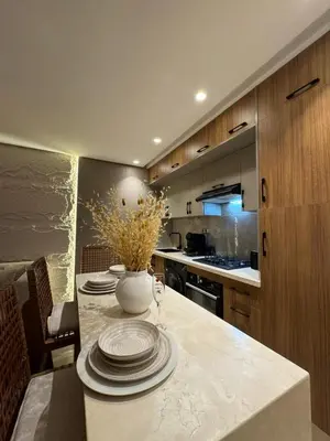 a kitchen with a table with plates on it at AquaEros - Appart Jacuzzi Carré Eden Marrakech in Marrakech
