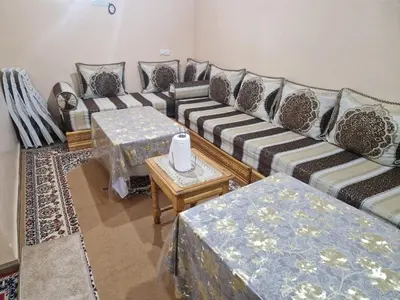a living room with a couch and a table at studio chez l'habitant in Marrakech
