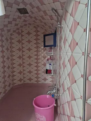 a pink bucket in a bathroom with a shower at studio chez l'habitant in Marrakech