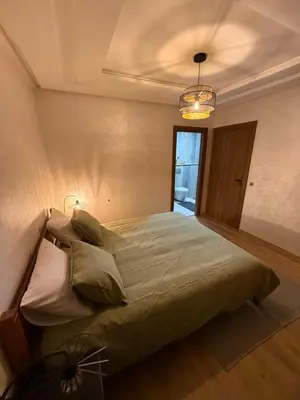 a bedroom with a large bed in a room at Appartement Marrakech 2 Chambres De Luxe Marron in Marrakech