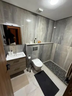 a bathroom with a toilet and a sink at Appartement Marrakech 2 Chambres De Luxe Marron in Marrakech