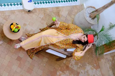 a woman in a dress laying on a chair at Riad Zellige in Marrakech